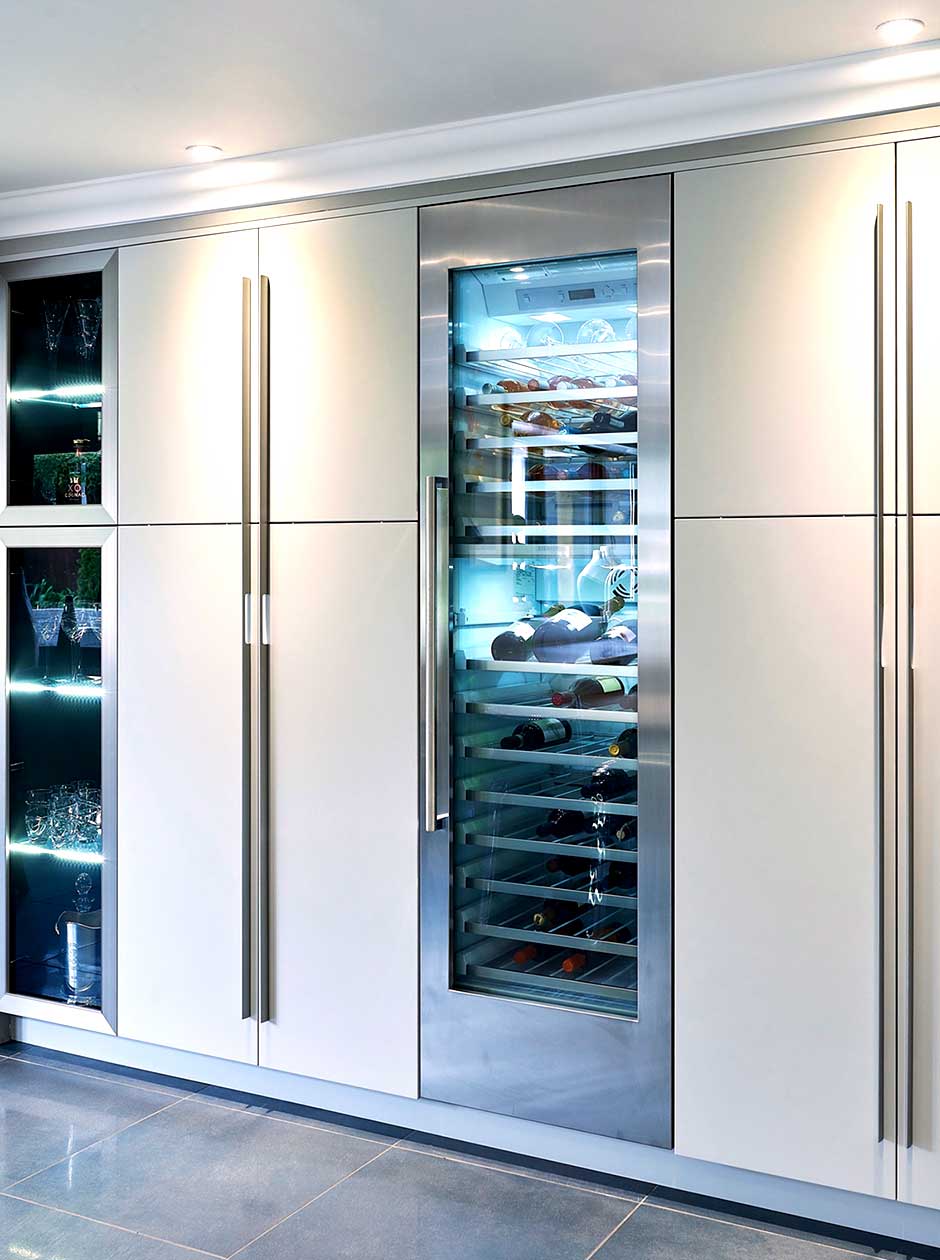Bespoke modern kitchen with large wine cooler and glass kitchen cupboard in Sutton Coldfield