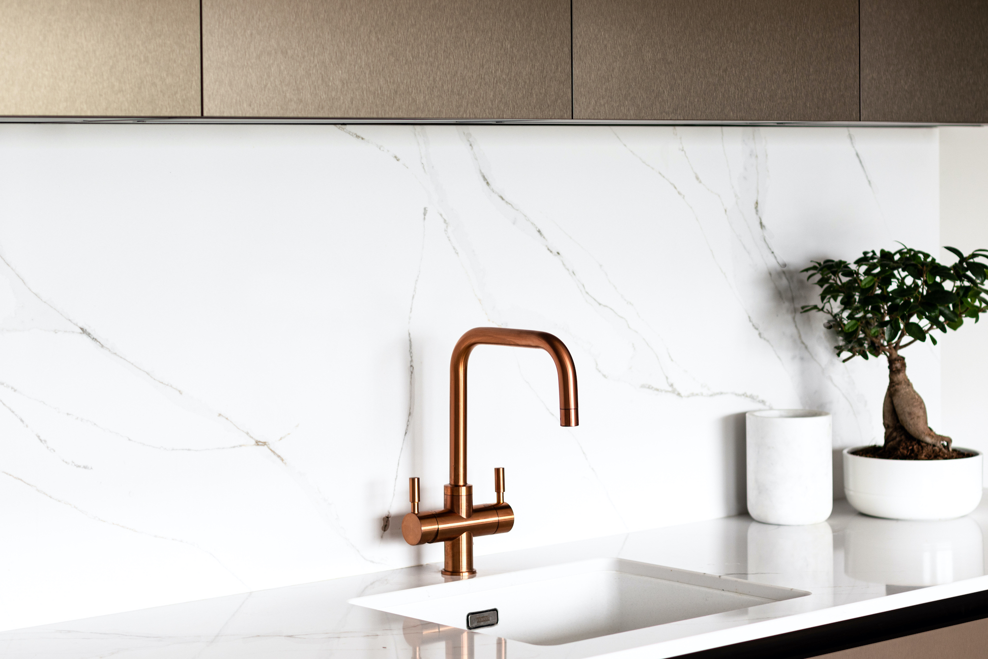 Copper Tap in a modern kitchen with marble splash back