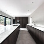 Stunning dark wood kitchen with large kitchen island. Kitchen extension in Coventry with Bora hob and wood texture. Bespoke Italian Luxury kitchen